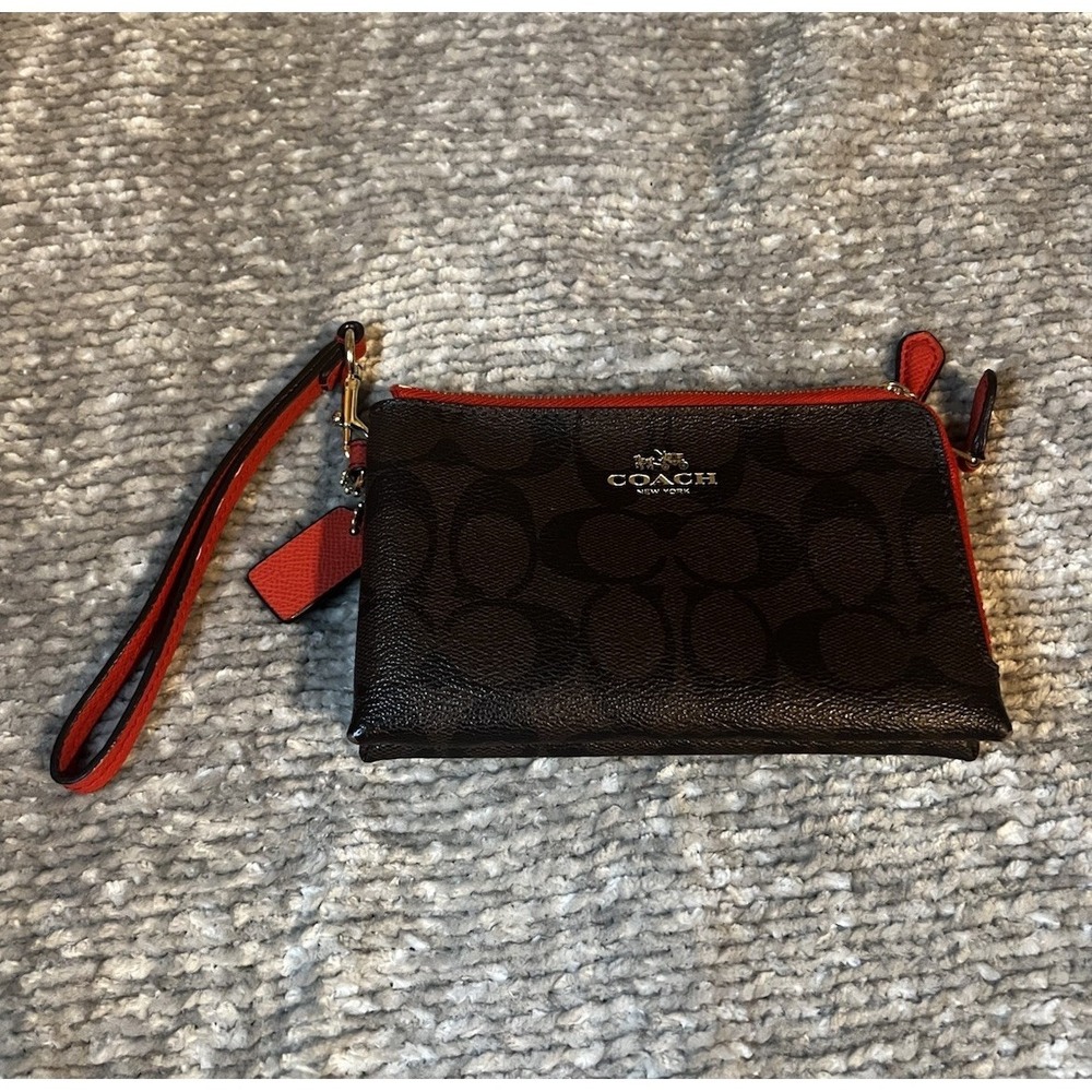 Coach Signature PVC Double Corner Zip Wristlet with red trim.